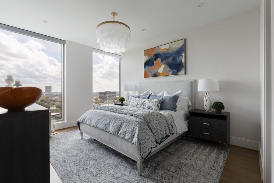 Where the horizon meets your headboard. This primary suite isn't just a bedroom; it’s a sprawling retreat designed for ultimate scale. There’s ample room for a full king-size suite, lounge seating, and the quiet luxury of space to breathe. With floor-to-ceiling glass framing the city, the room feels like a private island floating above the world. Where the horizon meets your headboard. This primary suite isn't just a bedroom; it’s a sprawling retreat designed for ultimate scale. There’s ample room for a full king-size suite, lounge seating, and the quiet luxury of space to breathe. With floor-to-ceiling glass framing the city, the room feels like a private island floating above the world.