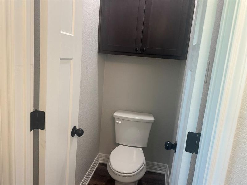 Bathroom featuring baseboards and wood finished floors