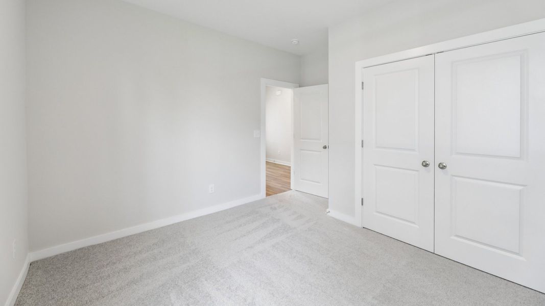 Bedroom with closet and carpet