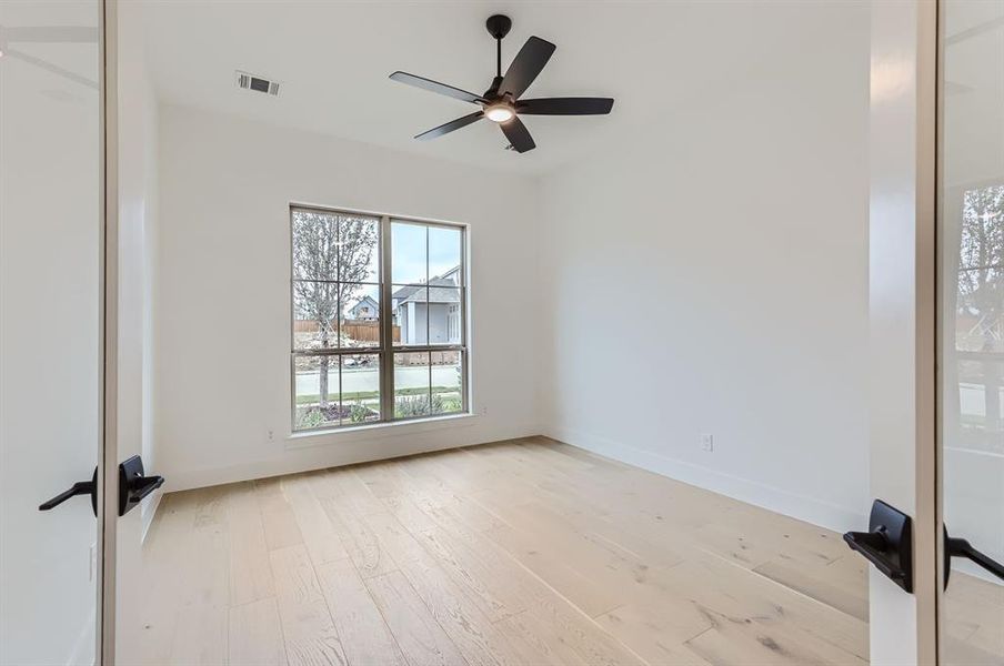 Unfurnished room with light hardwood / wood-style floors and ceiling fan