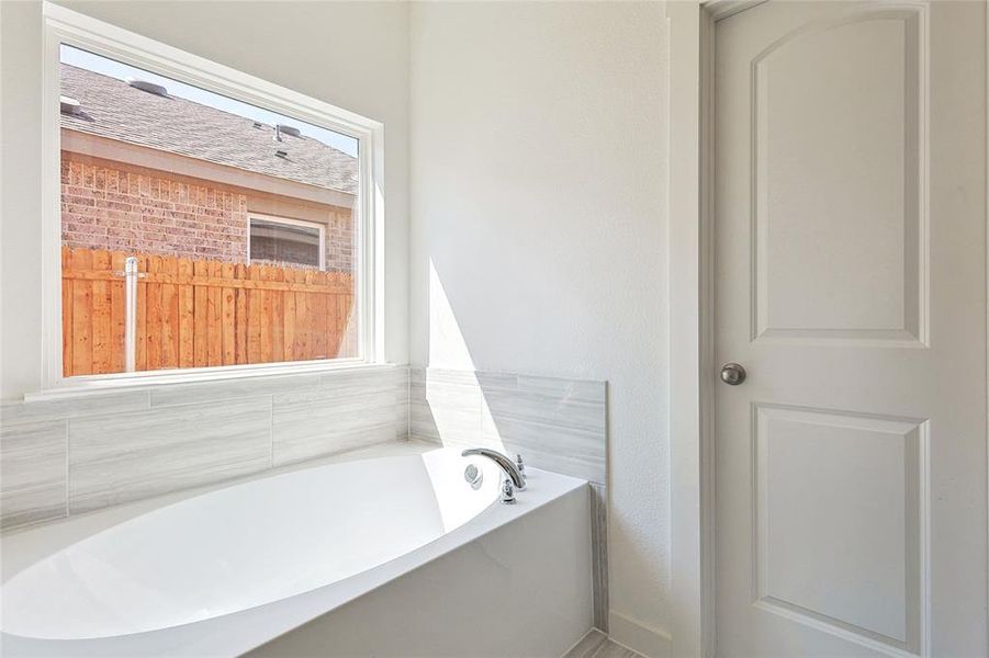 Full bathroom featuring a bath