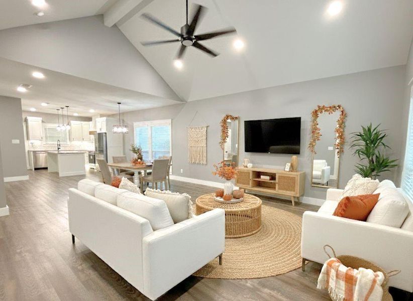 Living room featuring recessed lighting, ceiling fan, light wood-style floors, beam ceiling, and high vaulted ceiling Living room featuring recessed lighting, ceiling fan, light wood-style floors, beam ceiling, and high vaulted ceiling