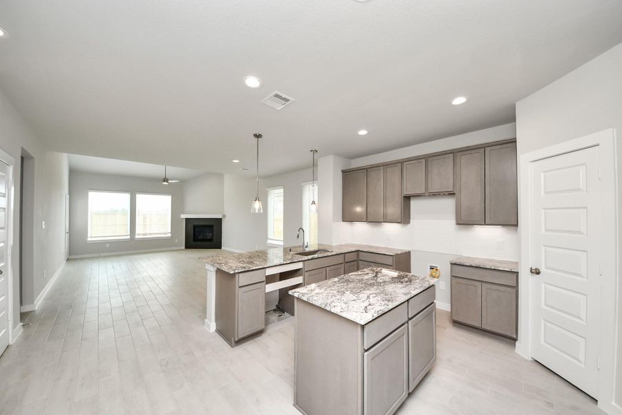 All of this overlooks your expansive family room, creating a perfect space for culinary delights and family gatherings. Sample photo of completed home with similar floor plan. Actual colors and selections may vary. All of this overlooks your expansive family room, creating a perfect space for culinary delights and family gatherings. Sample photo of completed home with similar floor plan. Actual colors and selections may vary.