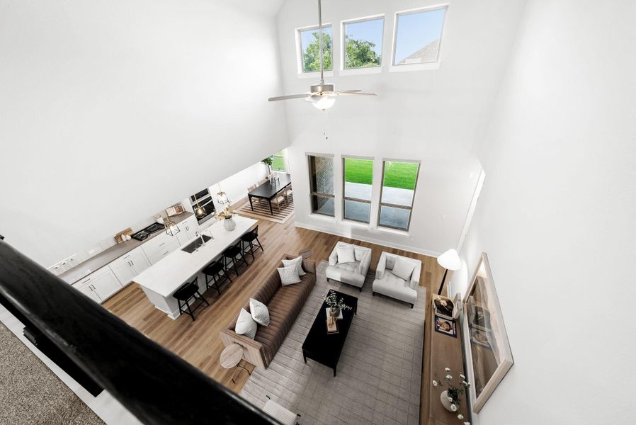 A striking overhead perspective reveals a light-filled open-concept living space with soaring ceilings and abundant natural light.