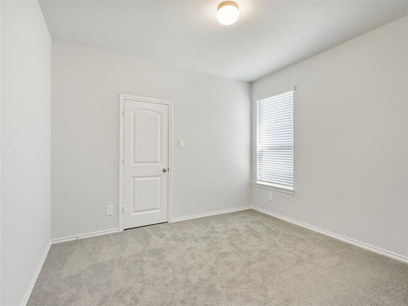 Carpeted spare room with baseboards Carpeted spare room with baseboards
