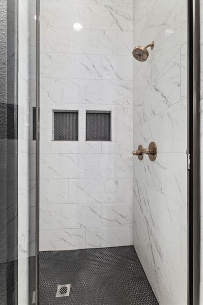 Full bath featuring a shower stall Full bath featuring a shower stall