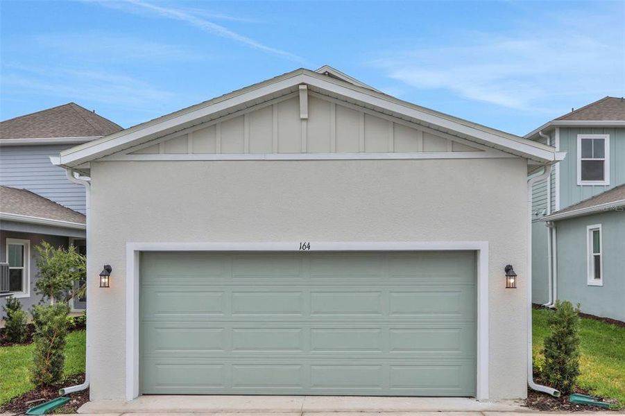 Front exterior of a new home in Bungalow Walk at Lakewood Ranch, Sarasota, FL, highlighting curb appeal (Image 16).