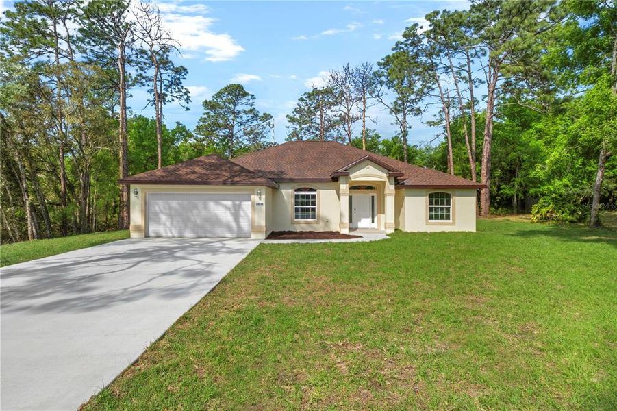 Front exterior of a new home in , Dunnellon, FL, highlighting curb appeal (Image 32).