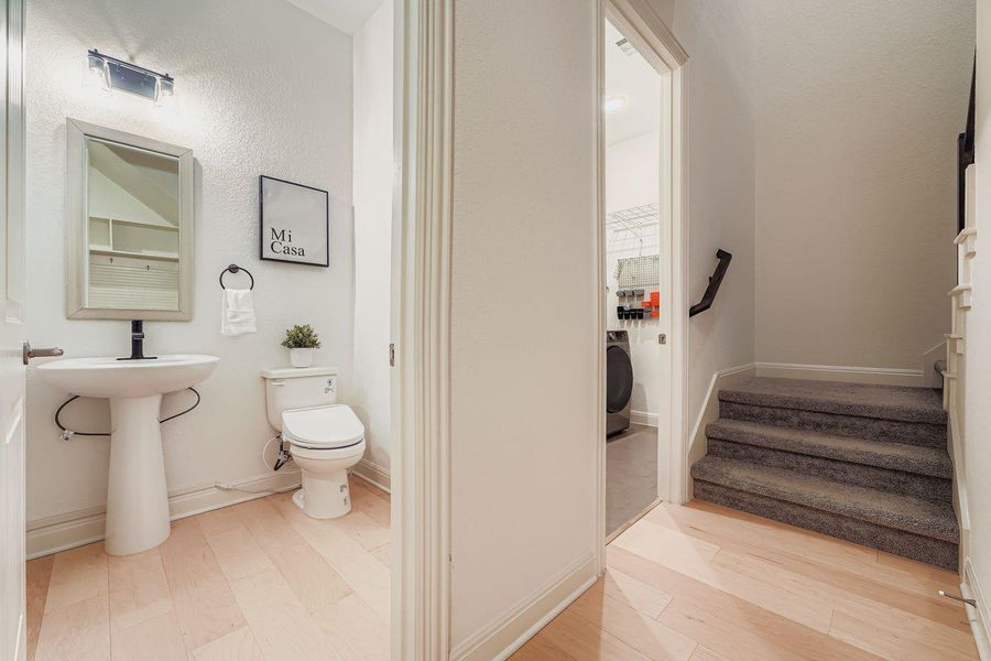 Bathroom with washer / dryer and light wood-style flooring Bathroom with washer / dryer and light wood-style flooring