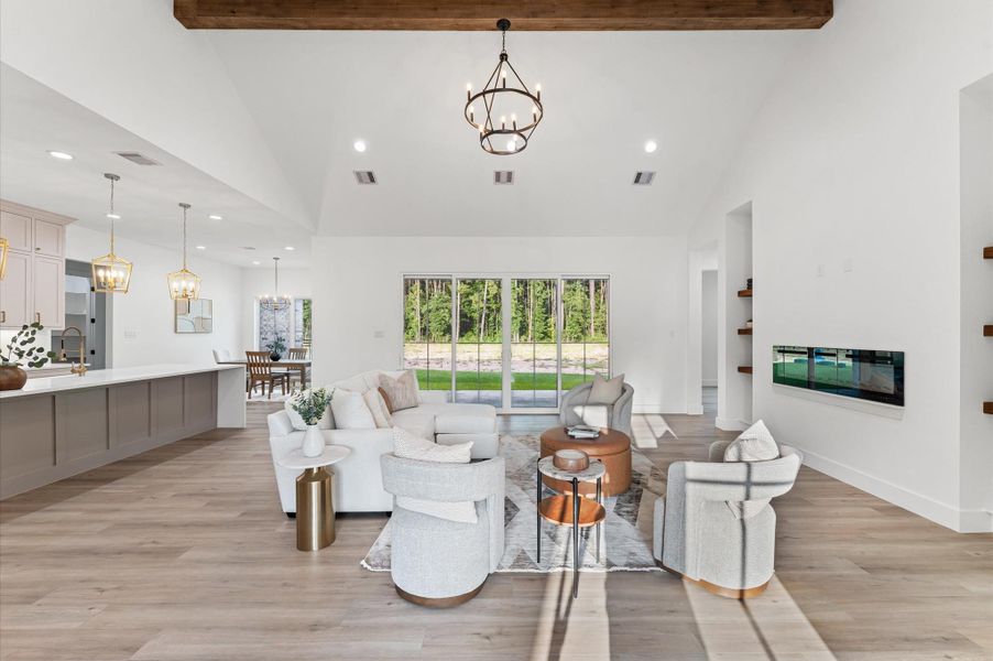 Open-concept living area with soaring cathedral ceilings, large windows for natural light, and LED recessed lighting throughout — a space where luxury meets comfort. Open-concept living area with soaring cathedral ceilings, large windows for natural light, and LED recessed lighting throughout — a space where luxury meets comfort.