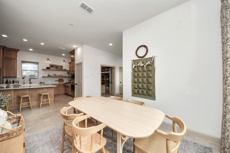 Dining area seamlessly connected to a modern custom kitchen.