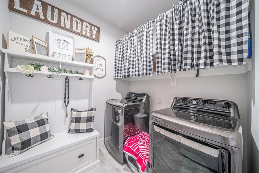 Washroom featuring separate washer and dryer and light wood-type flooring