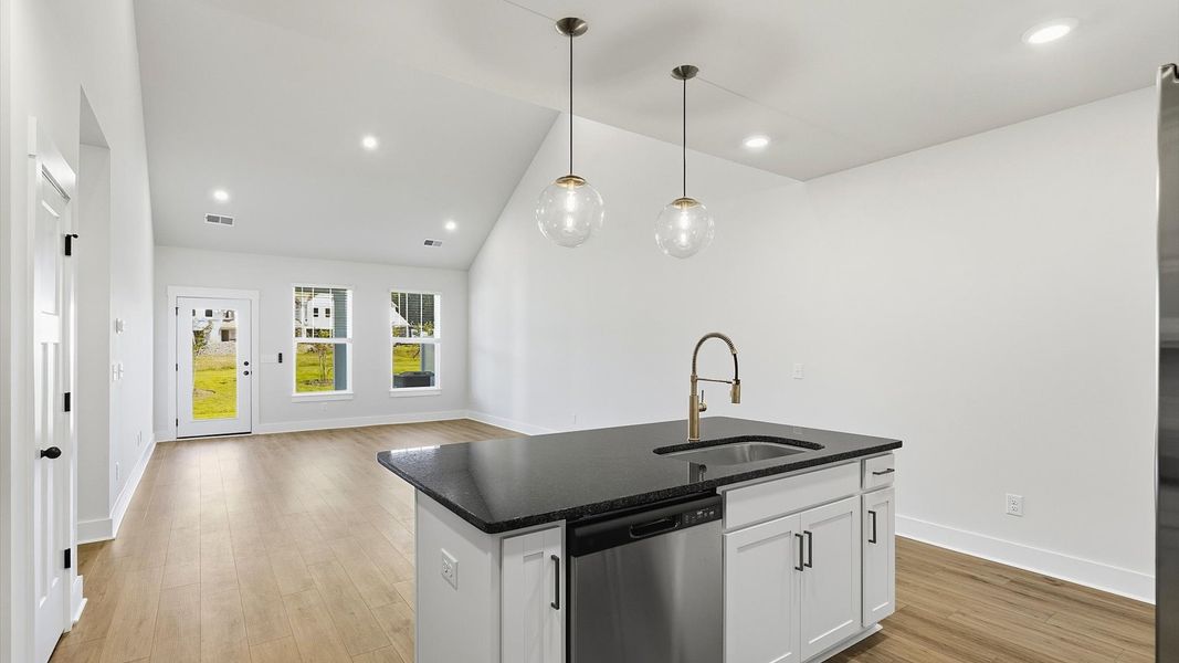 Notable kitchen space with elegant pendant lighting and a center island perfect for entertaining