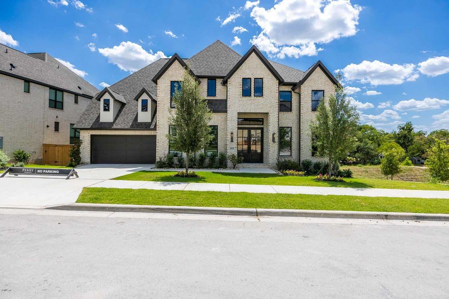 Front exterior of a new home in Palmera Ridge, Leander, TX, highlighting curb appeal (Image 2). Front exterior of a new home in Palmera Ridge, Leander, TX, highlighting curb appeal (Image 2).