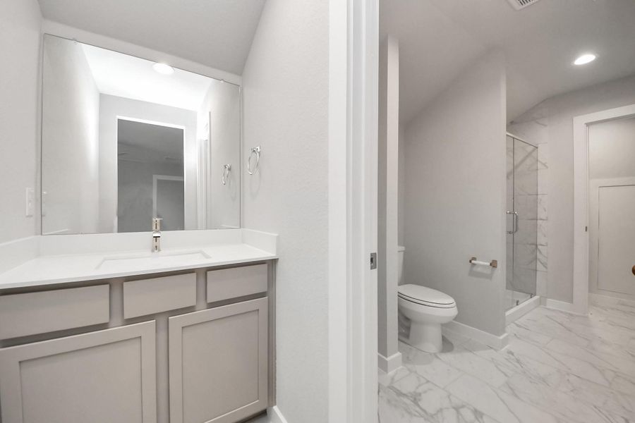 Experience convenience in the secondary bathroom, designed for Jack and Jill arrangements, now with a separate vanity area. This well-appointed space showcases stylish tile flooring, a bath/shower combo with an elegant tile surround, and light-stained wood cabinets. The beautiful light countertop adds a touch of sophistication, combining functionality and aesthetics seamlessly. Experience convenience in the secondary bathroom, designed for Jack and Jill arrangements, now with a separate vanity area. This well-appointed space showcases stylish tile flooring, a bath/shower combo with an elegant tile surround, and light-stained wood cabinets. The beautiful light countertop adds a touch of sophistication, combining functionality and aesthetics seamlessly.