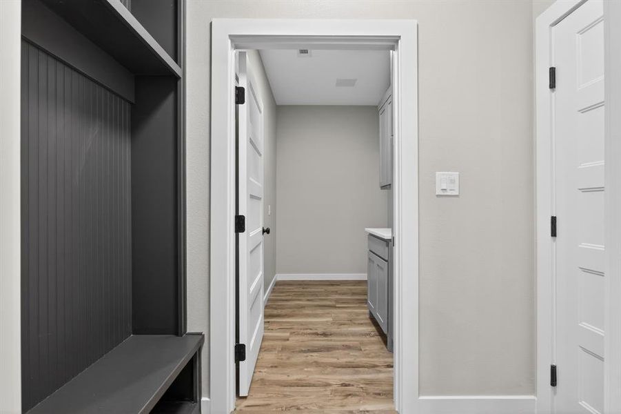 The garage entry opens up to a built-in storage area and the laundry room is immediately off to the right. This is a great space to keep things collected and organized!
