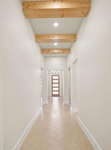 Hall with recessed lighting, beam ceiling, and baseboards