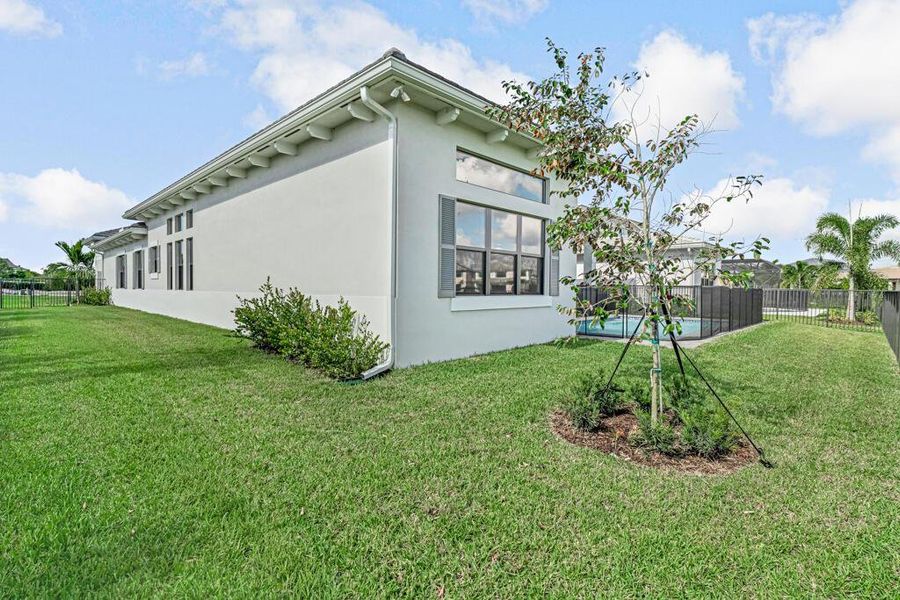 Front exterior of a new home in Apex at Avenir, Palm Beach Gardens, FL, highlighting curb appeal (Image 26). Front exterior of a new home in Apex at Avenir, Palm Beach Gardens, FL, highlighting curb appeal (Image 26).