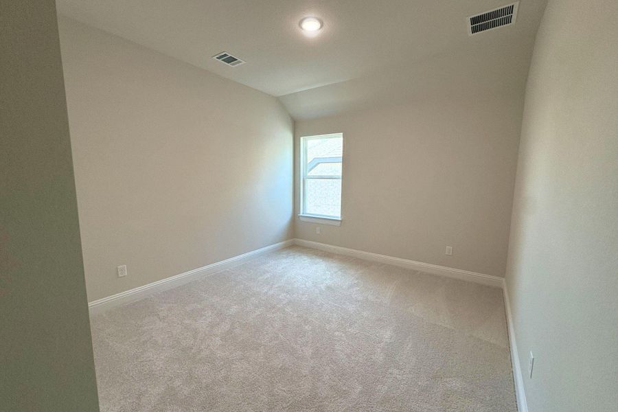 Neutral-toned room featuring a single window, recessed lighting, and light-colored carpet flooring