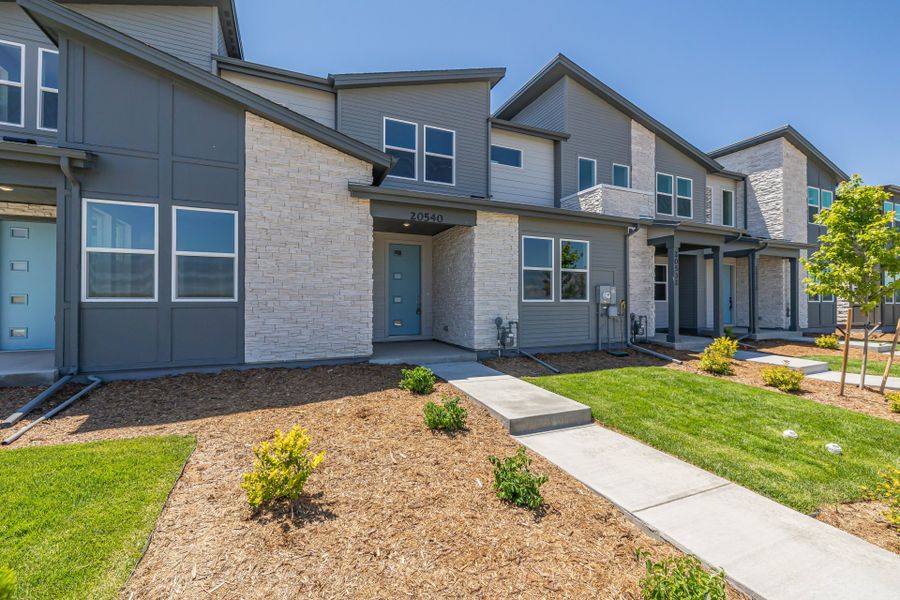 Front exterior of a new home in Painted Prairie, Aurora, CO, highlighting curb appeal (Image 22).