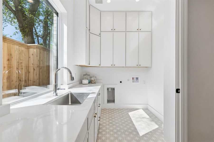 Laundry area featuring cabinet space, hookup for an electric dryer, light floors, hookup for a washing machine, and gas dryer hookup