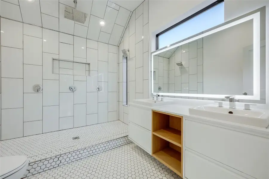 Full bathroom with double vanity, a stall shower, light tile patterned floors, and recessed lighting Full bathroom with double vanity, a stall shower, light tile patterned floors, and recessed lighting
