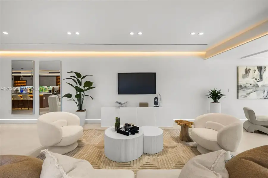 Modern interior featuring recessed lighting, cove ceiling accents, smooth wall finishes, and integrated custom cabinetry Modern interior featuring recessed lighting, cove ceiling accents, smooth wall finishes, and integrated custom cabinetry