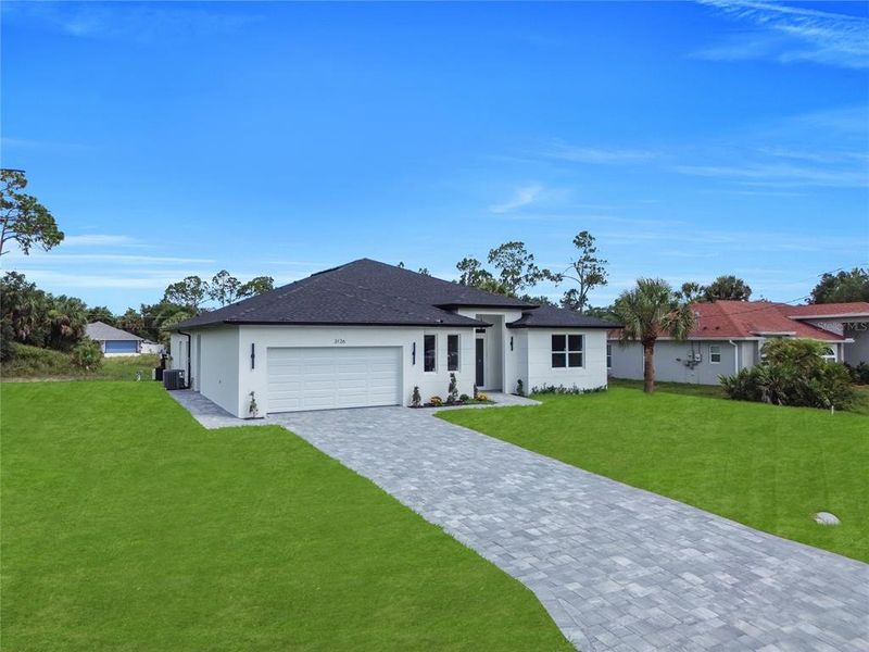 Front exterior of a new home in , North Port, FL, highlighting curb appeal (Image 2). Front exterior of a new home in , North Port, FL, highlighting curb appeal (Image 2).
