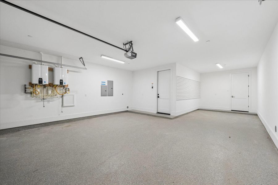 3 car garage! Tankless water heaters shown here as well and epoxied floor.