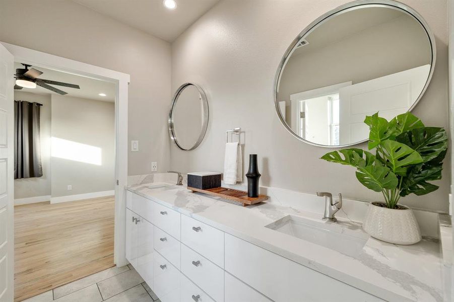 Bathroom with tile patterned flooring, ceiling fan, and vanity