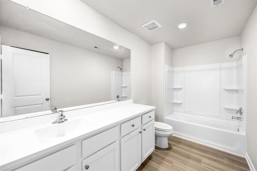 The secondary bathroom, located on the second floor of the home.