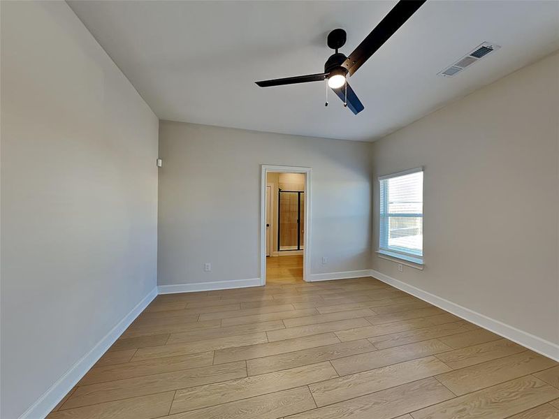 Spare room with light hardwood / wood-style floors and ceiling fan