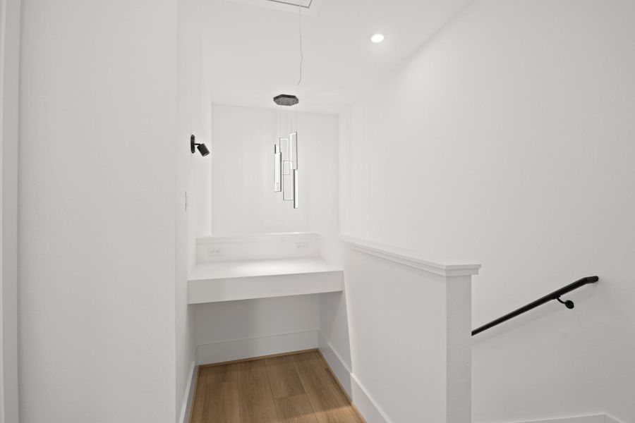 The third floor landing offers a space to work in privacy or use as a reading nook with overhead lighting and luxury vinyl plank flooring. The third floor landing offers a space to work in privacy or use as a reading nook with overhead lighting and luxury vinyl plank flooring.