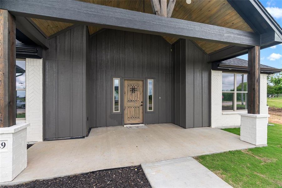 View of exterior entry featuring a patio