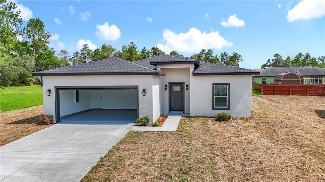 Front exterior of a new home in , Ocala, FL, highlighting curb appeal (Image 23).