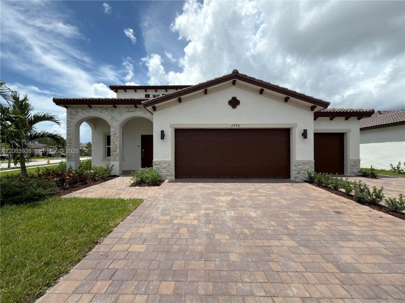 Front exterior of a new home in , Homestead, FL, highlighting curb appeal (Image 1). Front exterior of a new home in , Homestead, FL, highlighting curb appeal (Image 1).