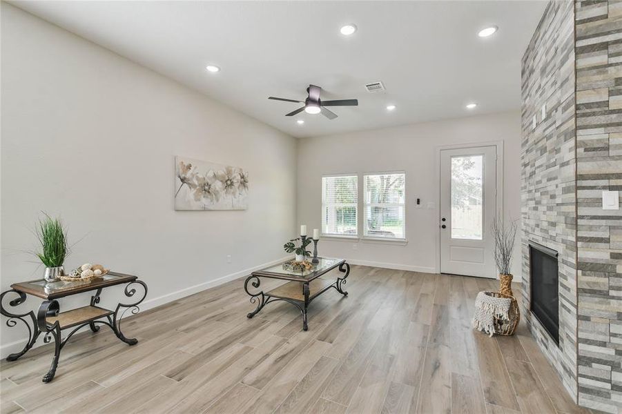 Spacious family room with floor to ceiling stone fireplace as the focal point.