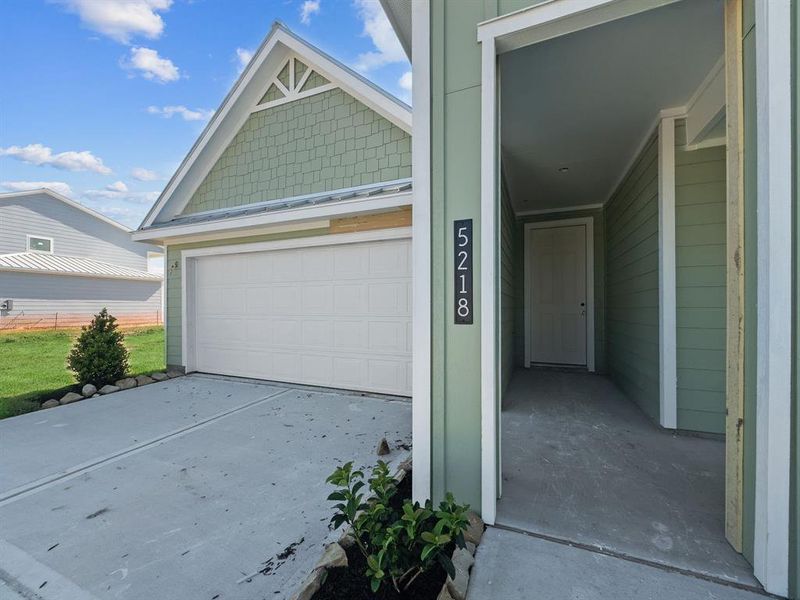 Front exterior of a new home in Grand Cay Harbour, Texas City, TX, highlighting curb appeal (Image 25). Front exterior of a new home in Grand Cay Harbour, Texas City, TX, highlighting curb appeal (Image 25).