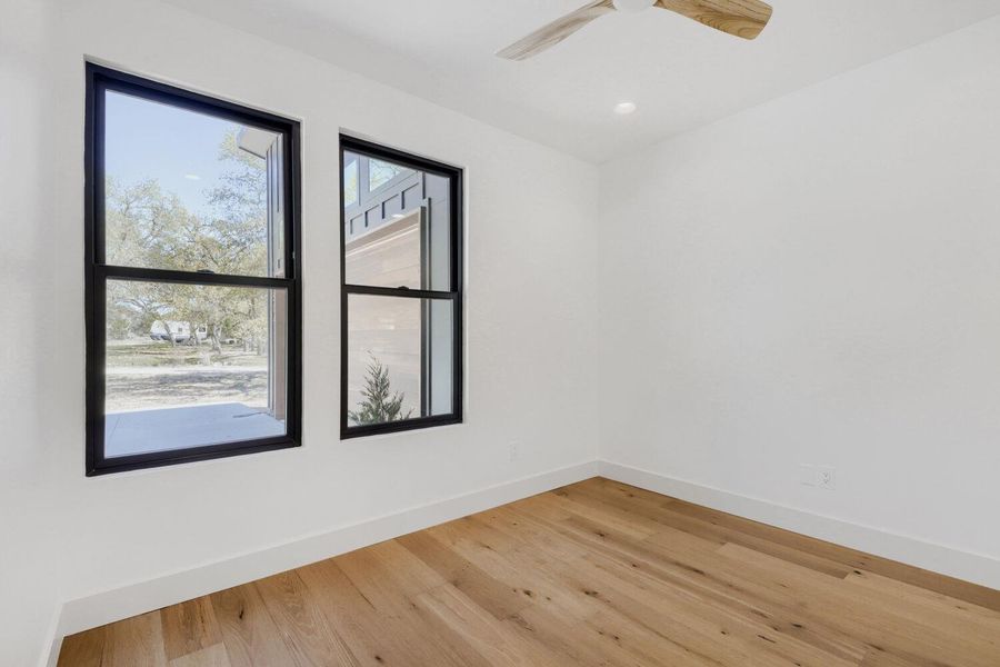 Unfurnished room featuring light wood-style floors and a ceiling fan Unfurnished room featuring light wood-style floors and a ceiling fan