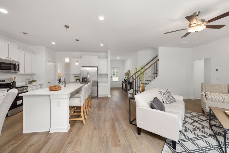 The kitchen overlooks the sunlit breakfast room and the spacious living room