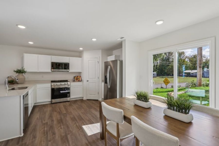 A kitchen with a table and chairs. A kitchen with a table and chairs.