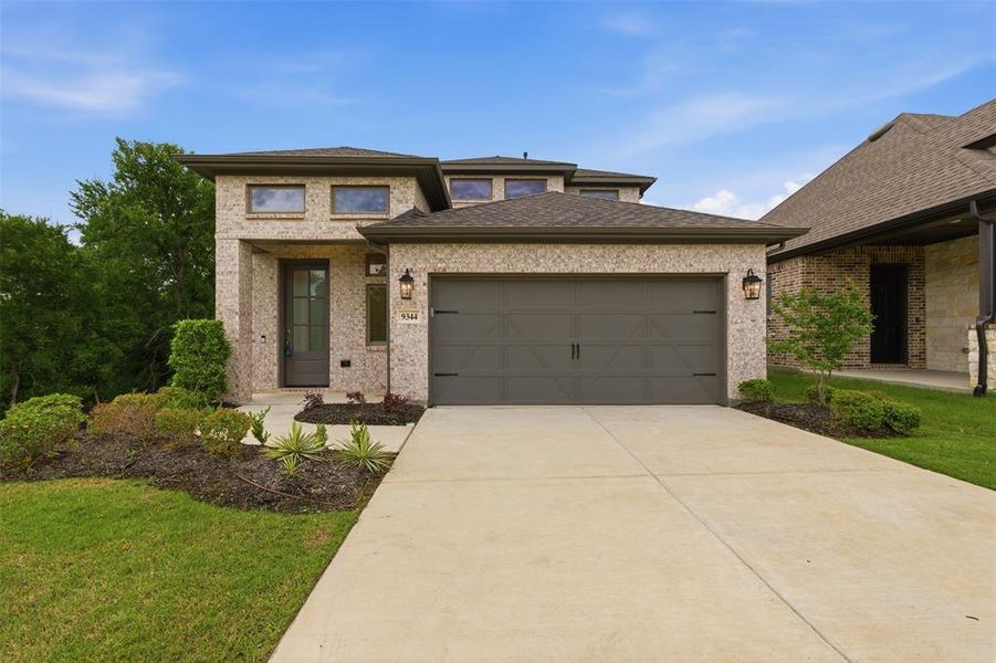 Front exterior of a new home in Prairie Oaks, Oak Point, TX, highlighting curb appeal (Image 21). Front exterior of a new home in Prairie Oaks, Oak Point, TX, highlighting curb appeal (Image 21).