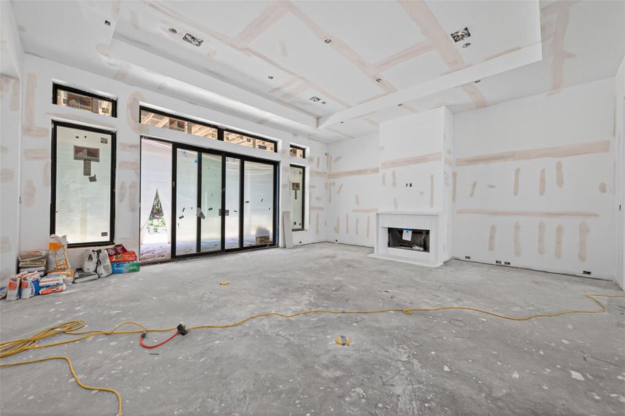 Spacious 24'x22' family room featuring glass sliders leading to the covered patio and stonecast fireplace