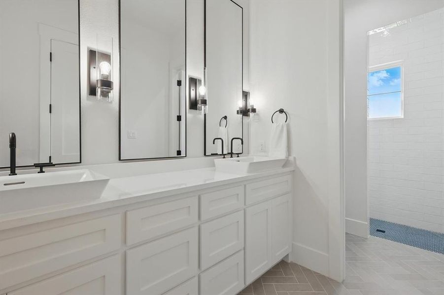 Bathroom with double vanity, a tile shower, and tile patterned flooring Bathroom with double vanity, a tile shower, and tile patterned flooring