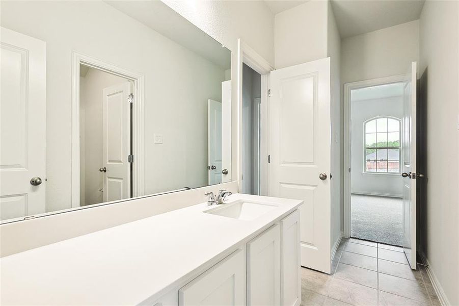 Bathroom featuring tile patterned flooring and vanity