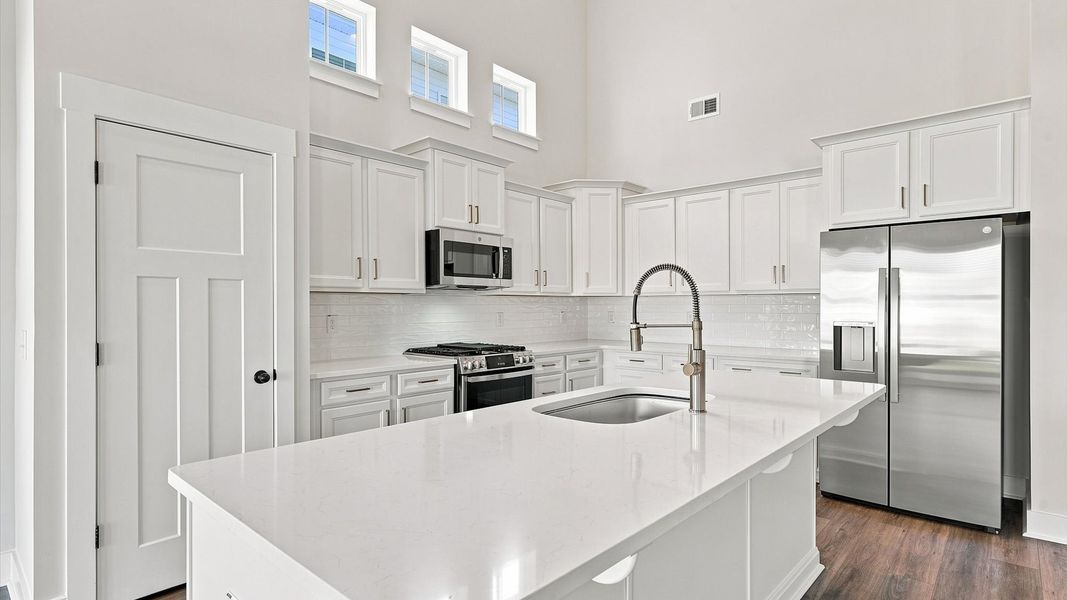 Elegant kitchen with large island in this first-class DRB Homes design Elegant kitchen with large island in this first-class DRB Homes design