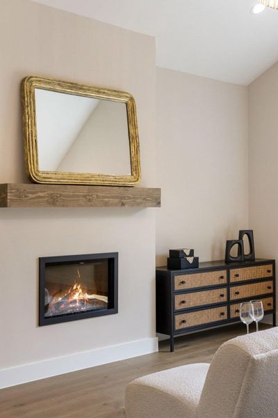 A chic living space featuring a cozy fireplace and contemporary wood flooring.