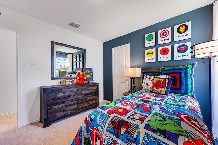 Bedroom featuring light colored carpet