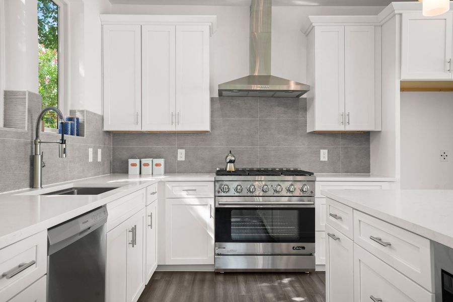 Culinary adventures await in this naturally illuminated kitchen, featuring pristine white cabinetry and sleek stainless steel appliances. Culinary adventures await in this naturally illuminated kitchen, featuring pristine white cabinetry and sleek stainless steel appliances.