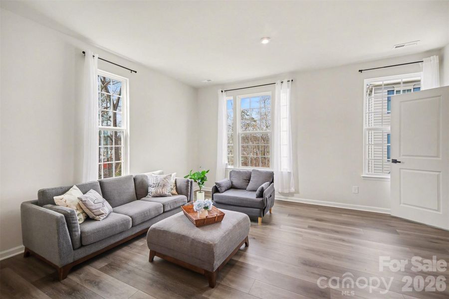 Living area with abundant natural light due to being an end-unit